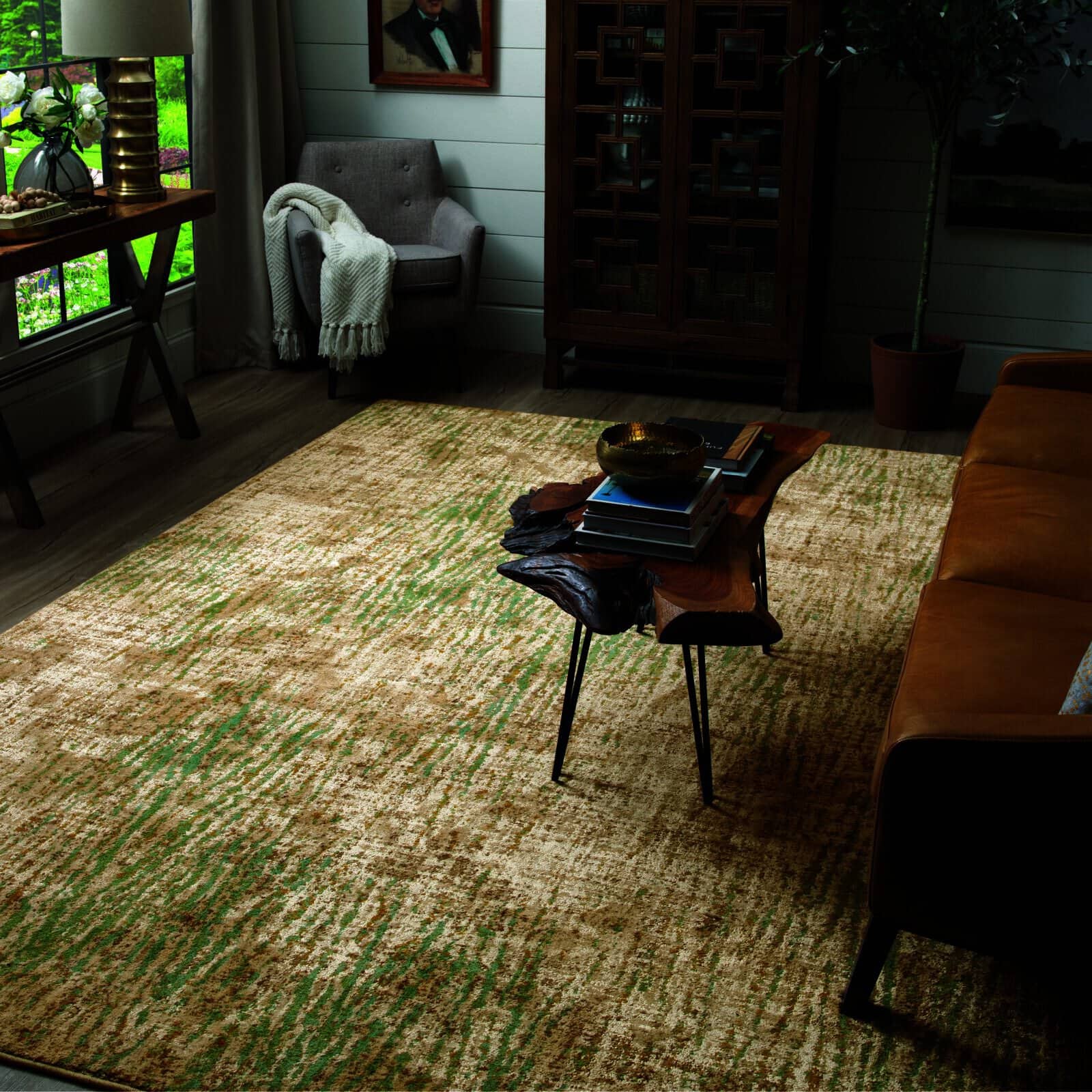 Cozy living room with earthy area rug, live edge coffee table, leather sofa, and accent chair