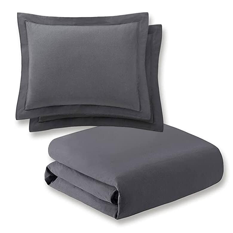 Dark gray bedding set with two matching pillow shams and a folded duvet