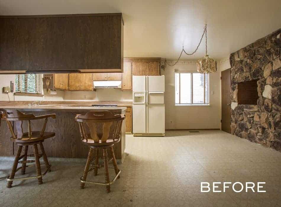 Vintage kitchen with wooden cabinets, stone fireplace, and retro bar stools