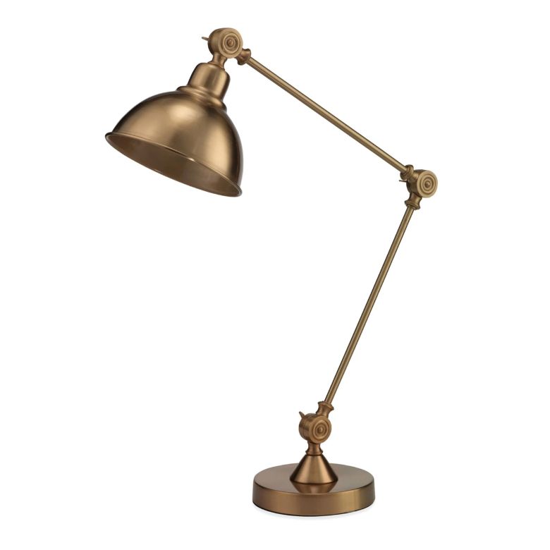 Brass adjustable desk lamp with an industrial-inspired design and a round base