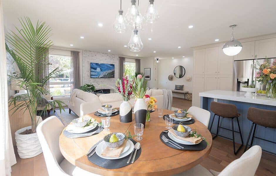 Modern dining and living area with round table and neutral decor