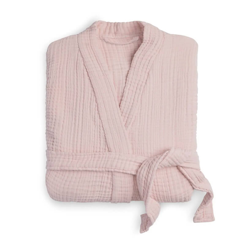 Folded light pink cotton robe with a textured fabric and waist tie