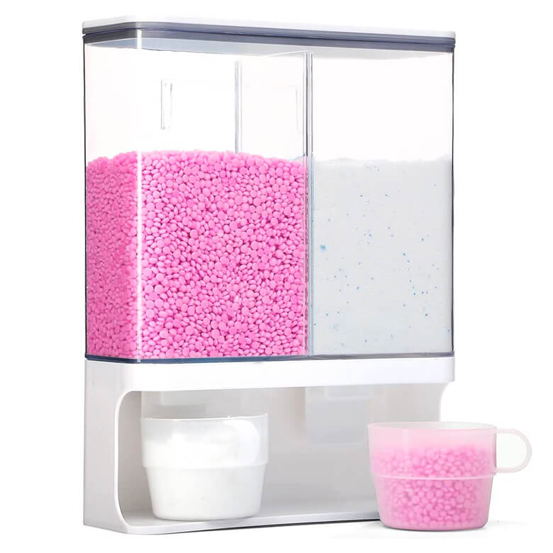 Dual-compartment dispenser with pink laundry beads and white detergent powder, shown with measuring cups