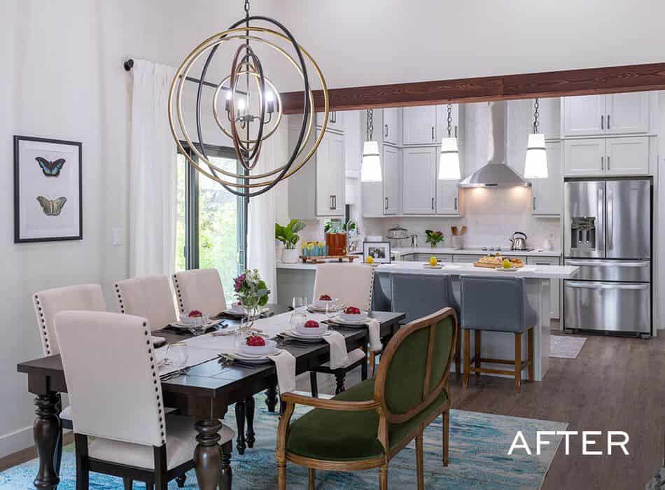 Dining room and kitchen featuring a wooden table, white cabinets, a geometric chandelier, and a kitchen island
