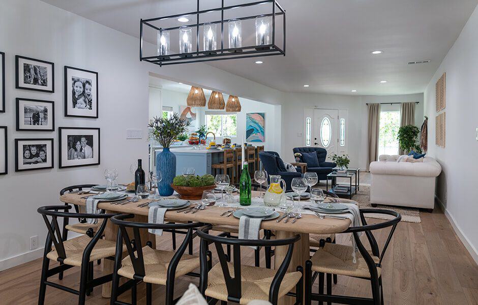 Elegant open-concept dining and living area with a set table