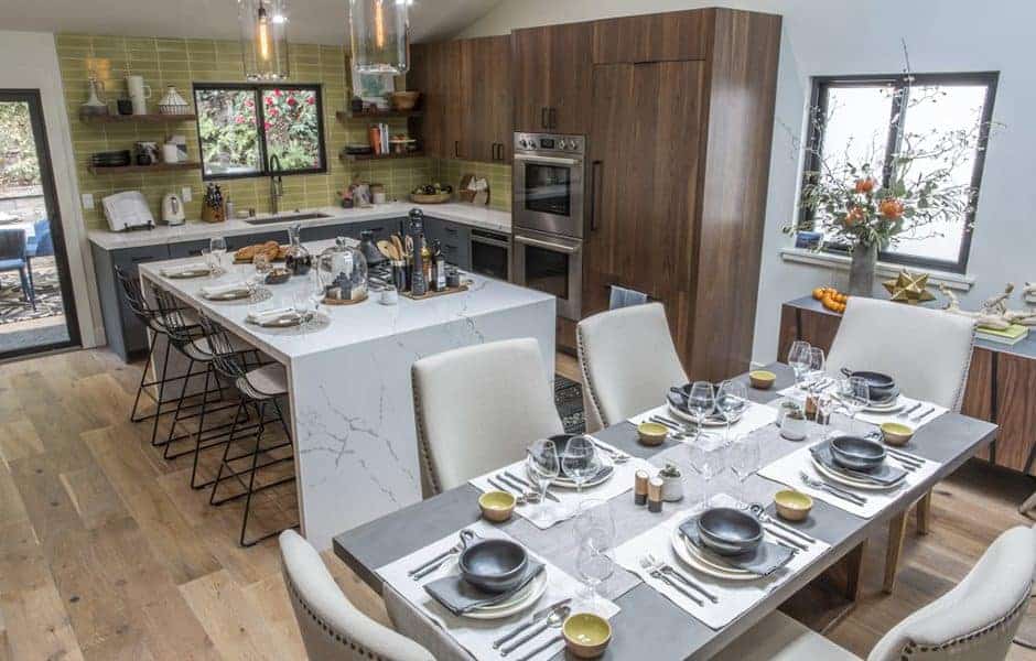 Kitchen and dining area with a large island and elegant table settings