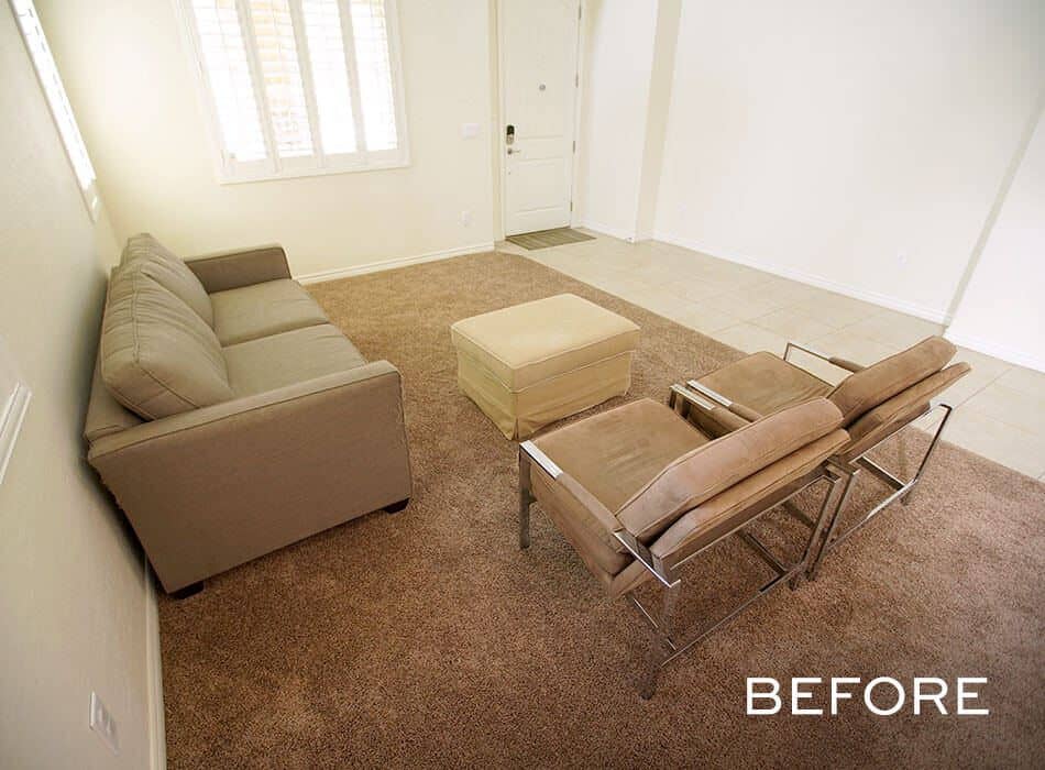 Minimalist living room with beige sofa brown carpet and metal-framed chairs