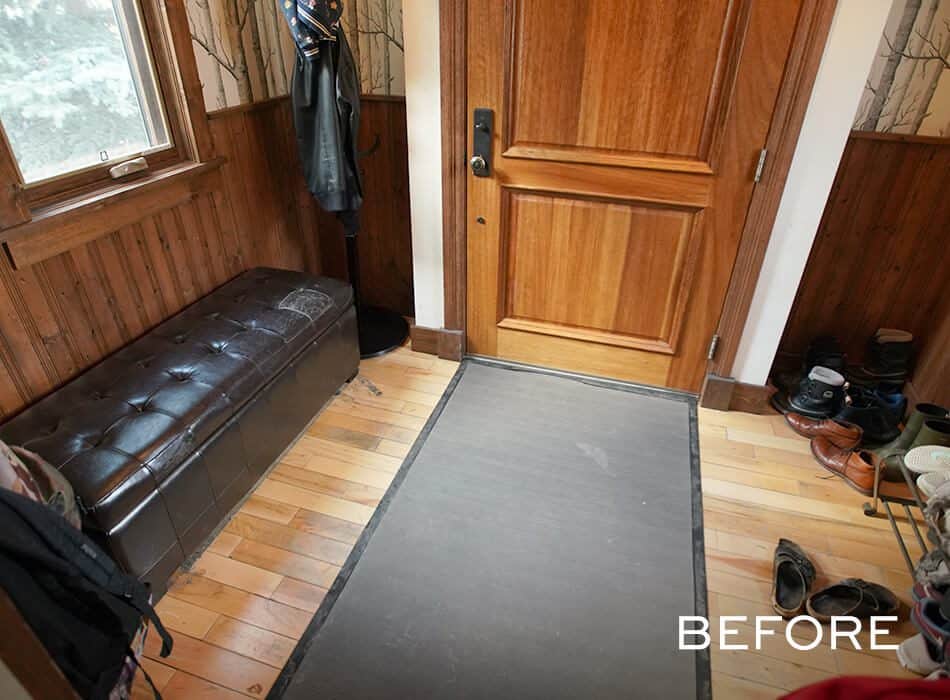 Interior entryway with wooden bench and scattered shoes before renovation
