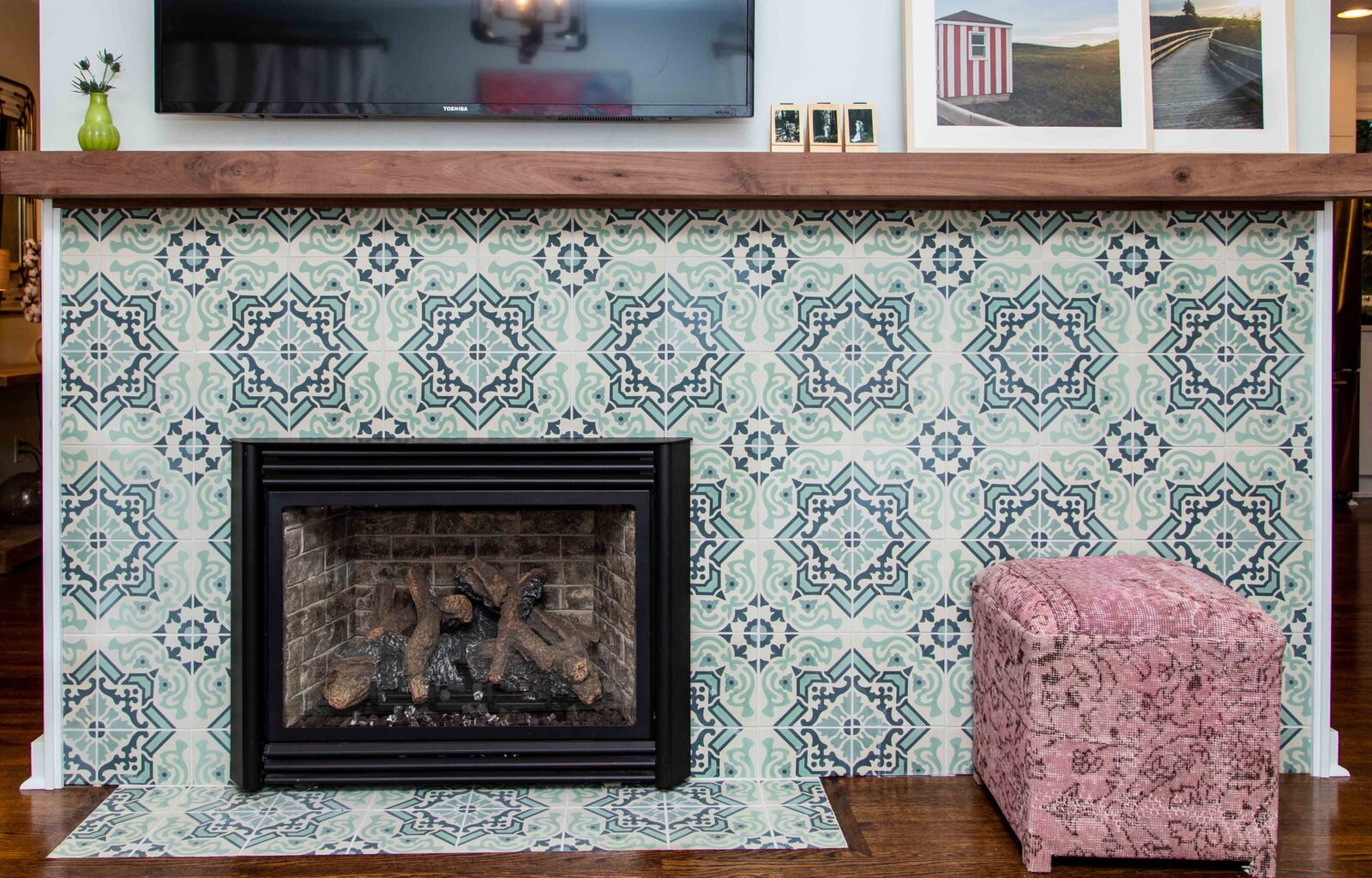 Patterned tile fireplace with wood mantel and pink upholstered bench