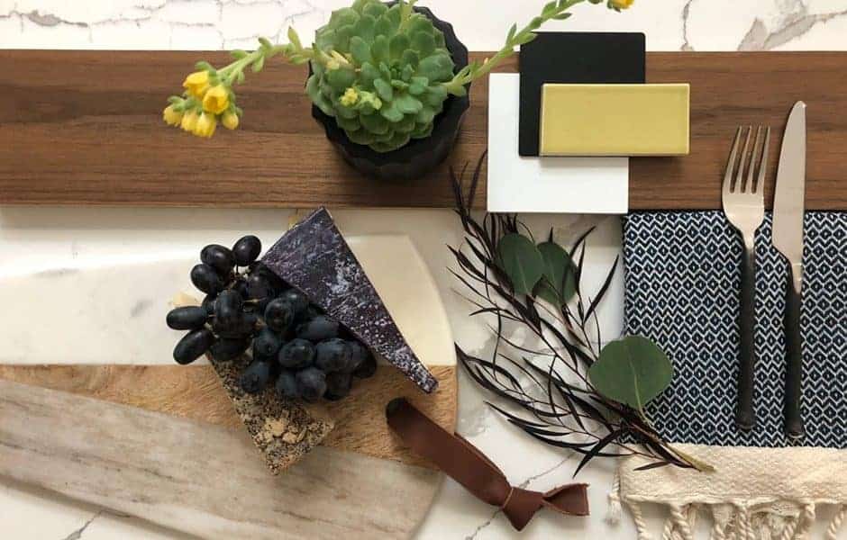 Styled table setting with grapes, greenery, and modern decor accents