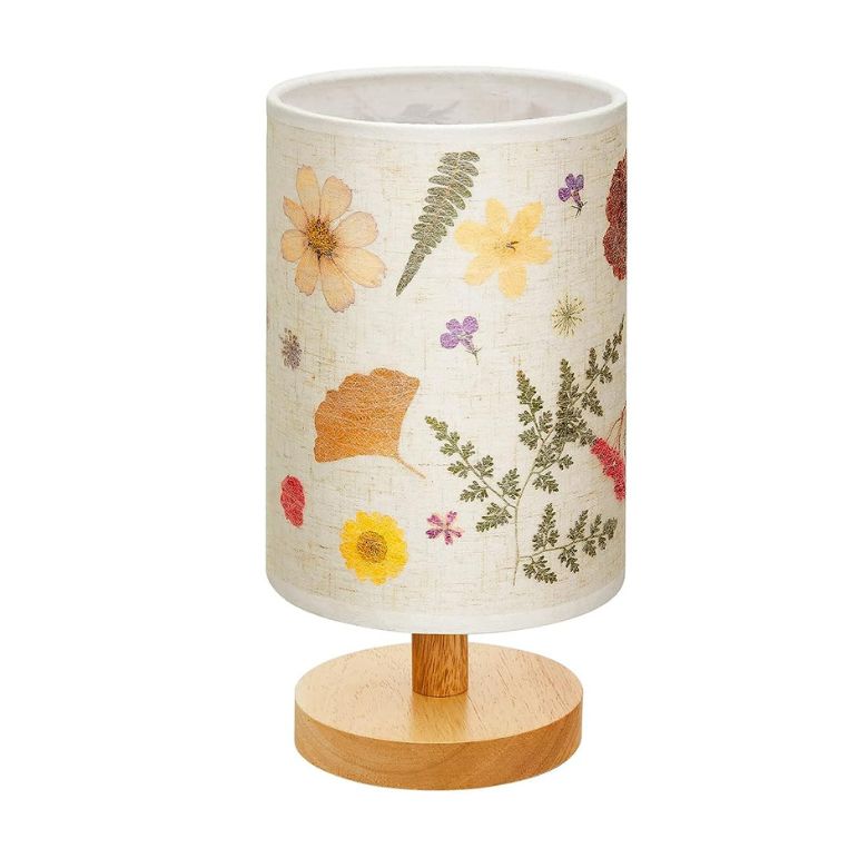 Table lamp with a cylindrical shade featuring pressed flower designs and a wooden base