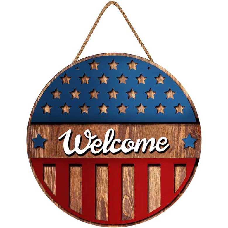 Round wooden welcome sign with red, white, and blue stars and stripes design