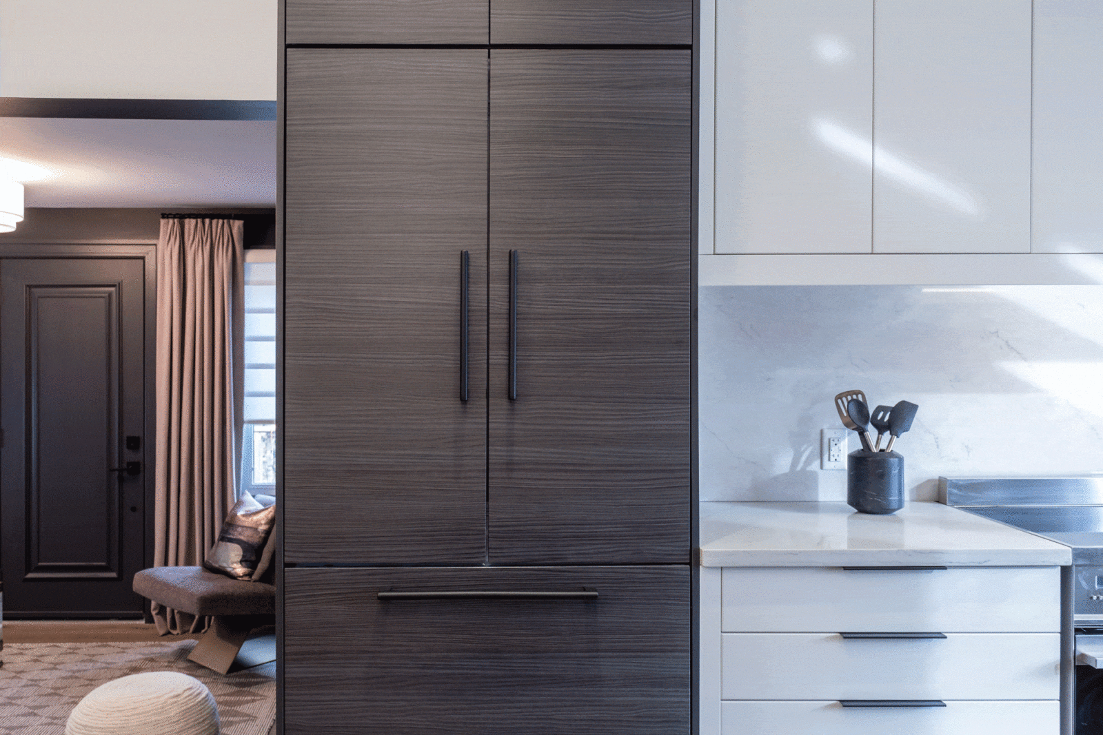 Built-in fridge with dark wood panels seamlessly integrated into the kitchen design