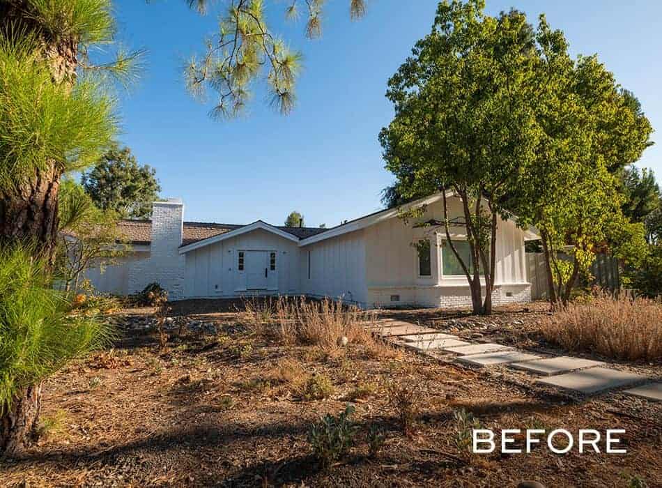 White single-story house with dry, overgrown front yard