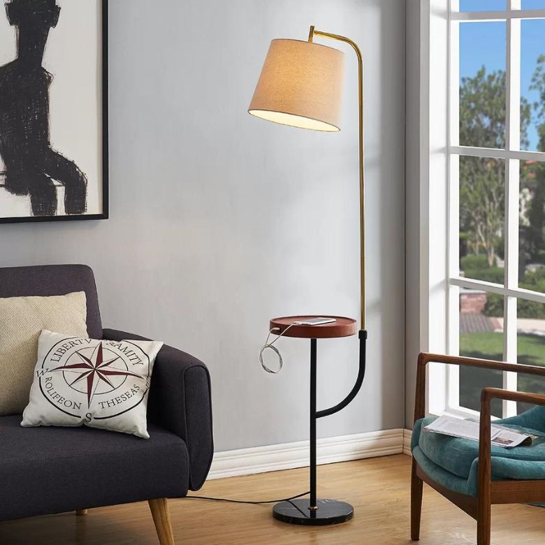 Floor lamp with a built-in side table and charging port in a cozy living room setting