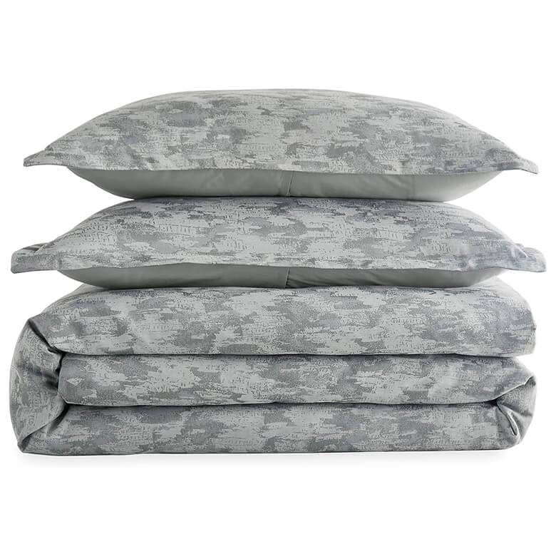 Stacked gray bedding set with a subtle abstract pattern, including two pillows and a folded comforter