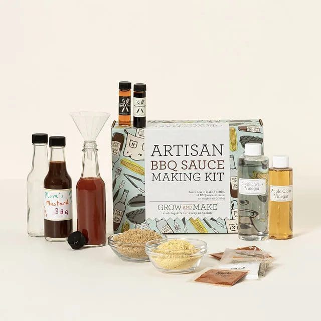 Artisan BBQ sauce making kit with bottles, spices, vinegars, and mixing tools