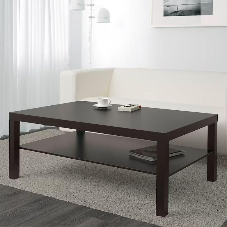 Black coffee table with lower storage shelf in a modern living room setting
