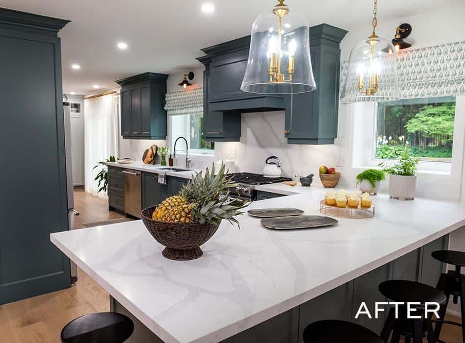 A renovated kitchen with dark teal cabinetry and a central island.