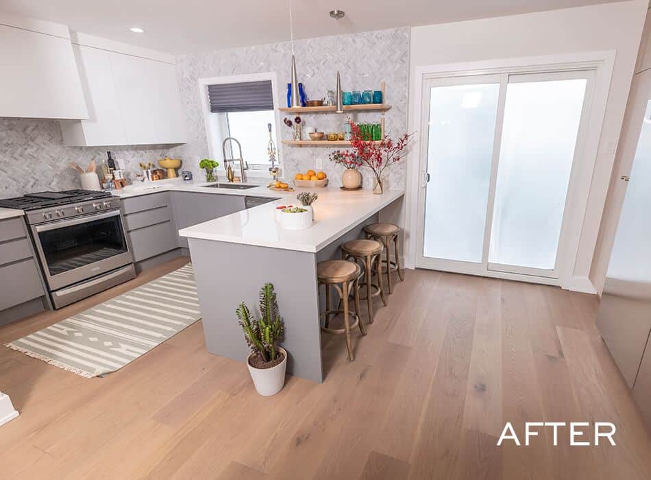 Kitchen with gray cabinets, white countertops, open shelving, and a large island with wooden stools