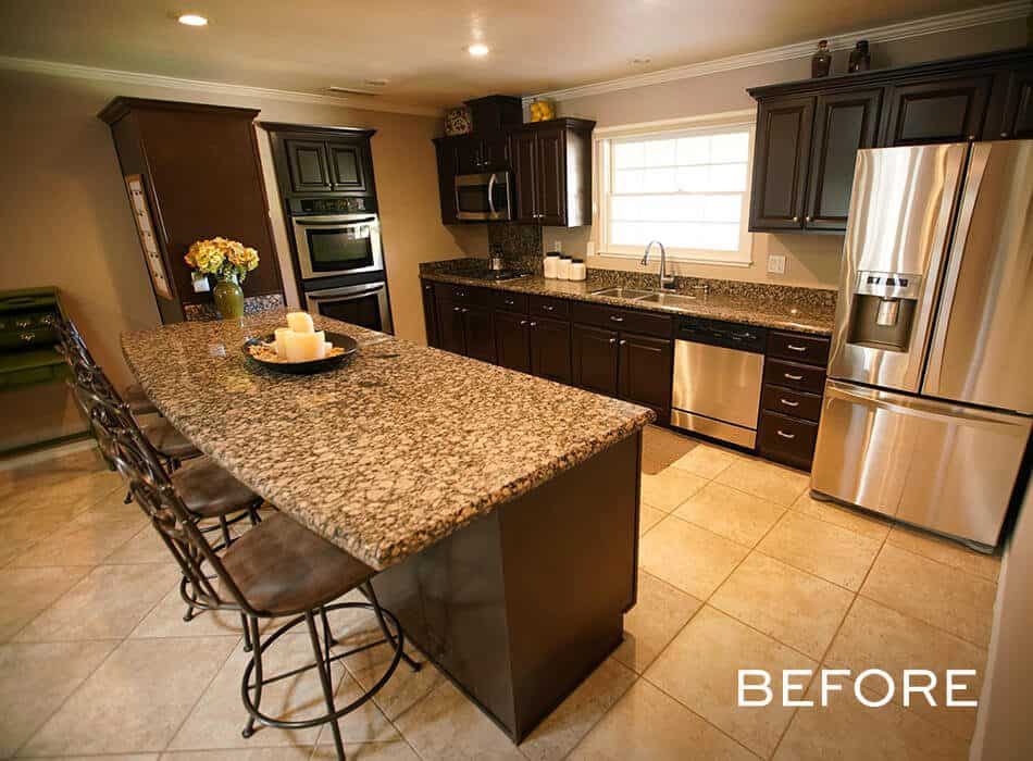 Dark wood kitchen with granite countertops, stainless steel appliances, and a large island