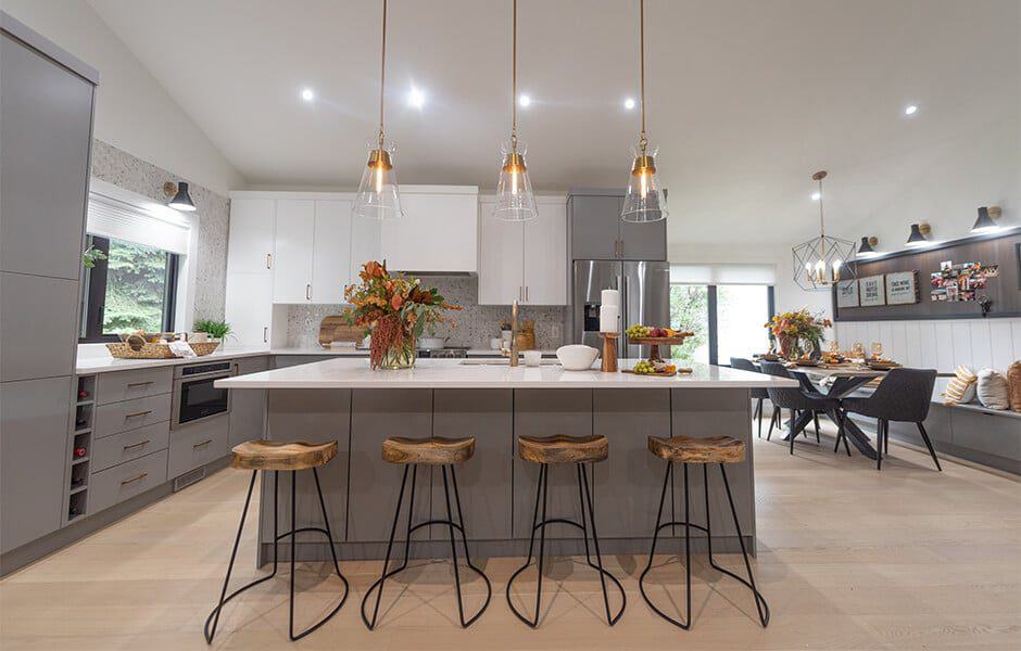 Modern kitchen with island, pendant lights, and wooden barstools