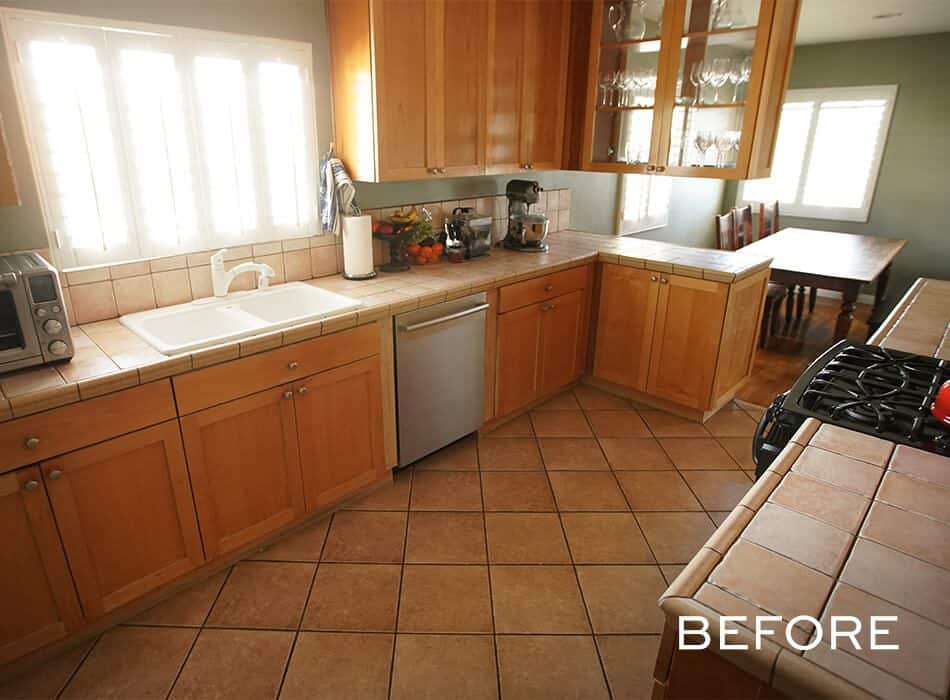 Before image of a traditional kitchen with wooden cabinets and tiled countertops