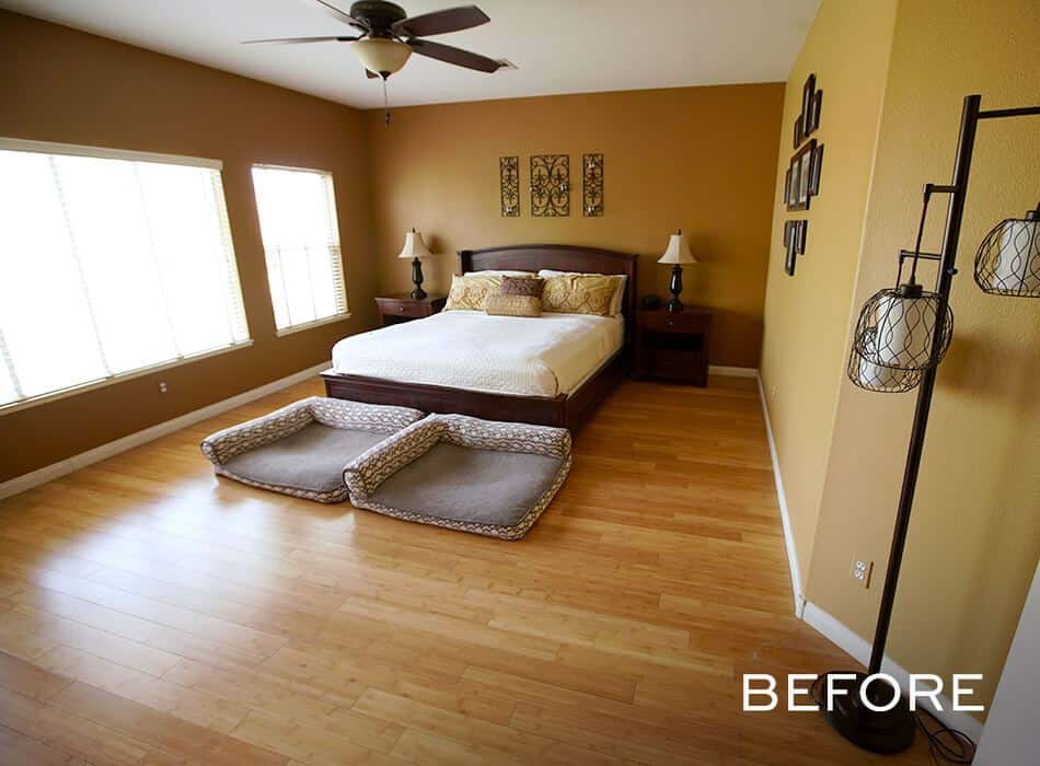 Bedroom with brown walls, wooden flooring, and a queen bed with pet beds in front