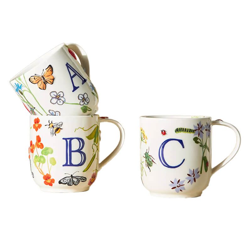 Set of three alphabet mugs with floral and insect illustrations, featuring letters A, B, and C
