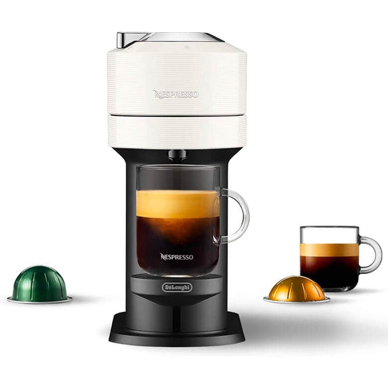 Nespresso coffee machine with a glass mug of espresso, shown alongside coffee pods and an additional cup of brewed coffee