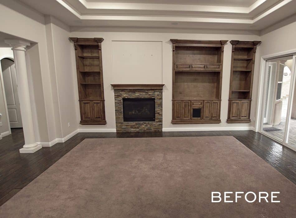 Traditional living room with built-in wooden shelves, fireplace, and recessed ceiling