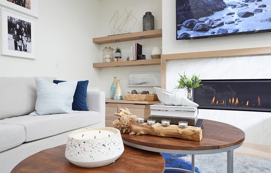 Living room with cozy fireplace, wooden coffee tables, and decorative accents