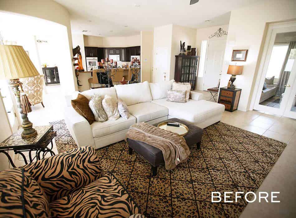 Living room with white sectional sofa, patterned rug, and animal-print armchairs