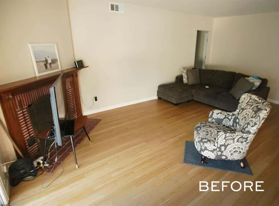 Living room with a sectional sofa, patterned armchair, and TV stand