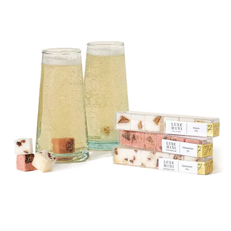 Two glasses of champagne with flavored sugar cubes and Luxe Mini boxes