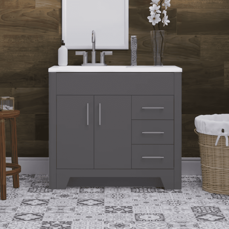 Gray bathroom vanity with drawers and cabinet doors, patterned tile floor, and wood panel wall