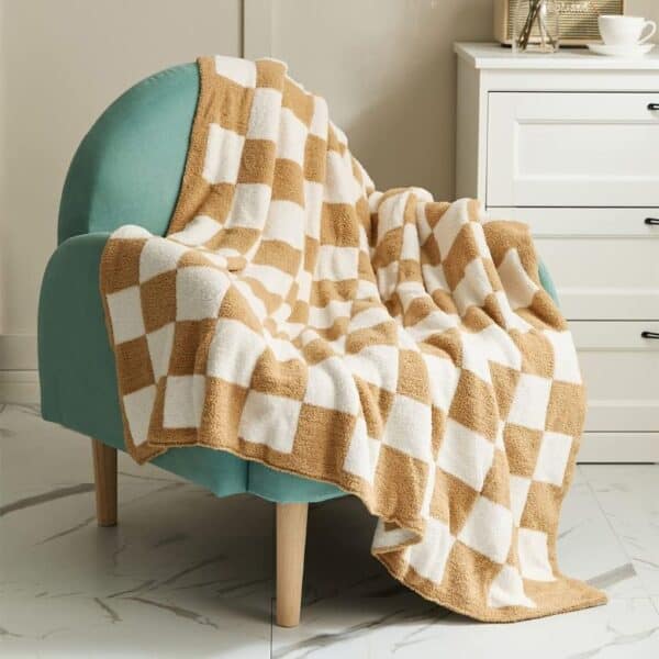 Cozy checkered throw blanket draped over a teal armchair in a modern living space