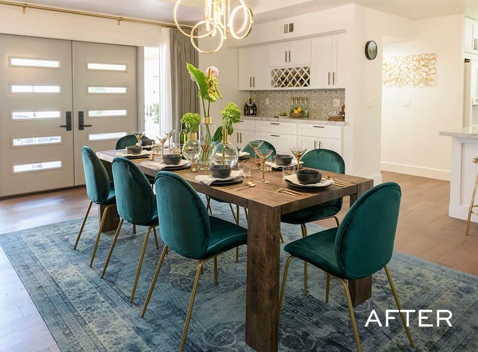 Dining room with a wooden table, teal chairs, and a modern chandelier