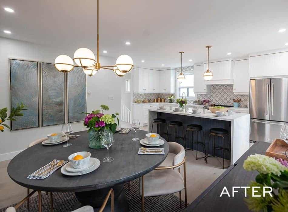 Modern kitchen and dining area with a black table and white island