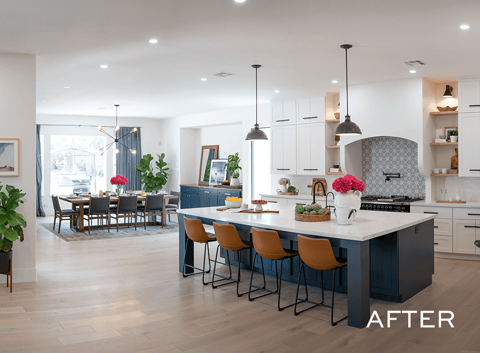 Modern kitchen with island and dining area after renovation.
