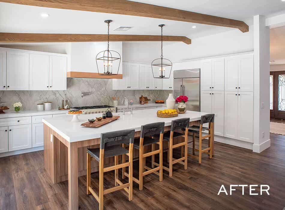 Farmhouse kitchen with a large island, wood beams, and pendant lighting