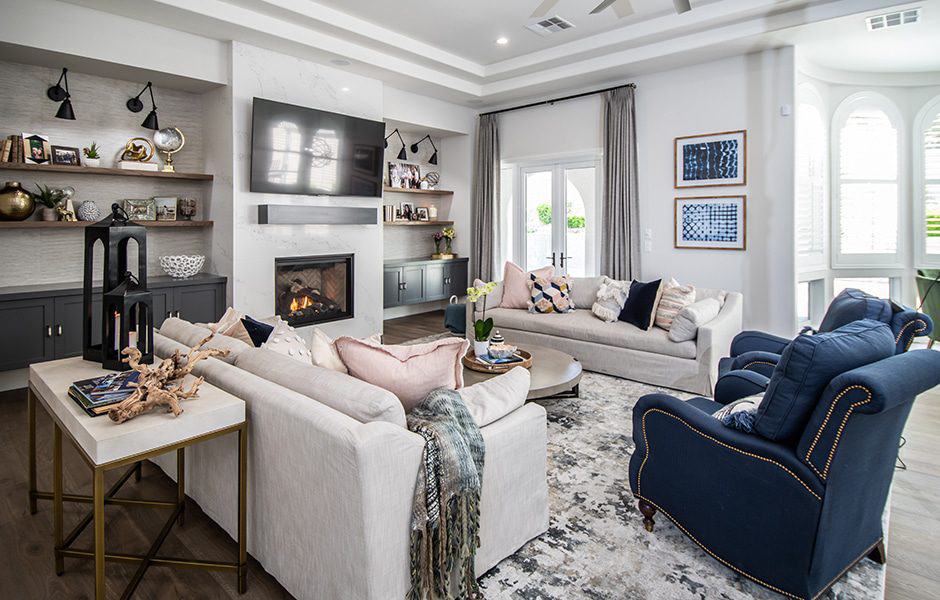 A cozy living room with a fireplace, comfy seating, and modern decor