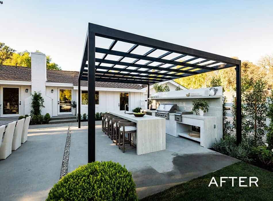 Modern outdoor kitchen with pergola, stone island seating, built-in grill, and stylish dining area