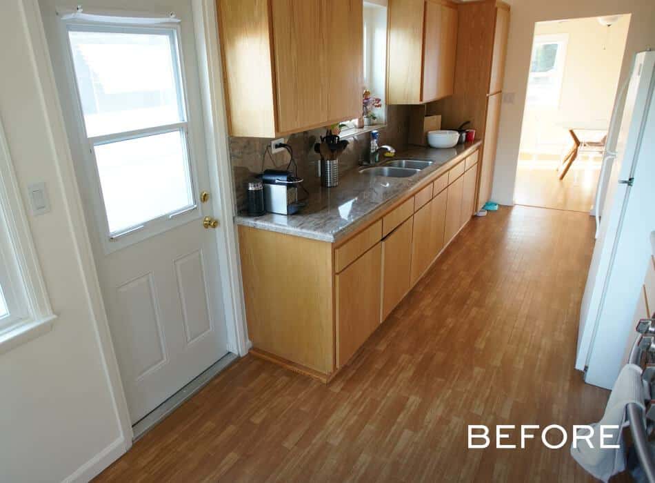 Narrow kitchen with wooden cabinets granite countertops and light hardwood flooring