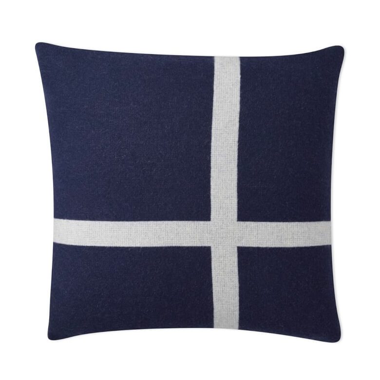 Navy blue throw pillow with a white cross design