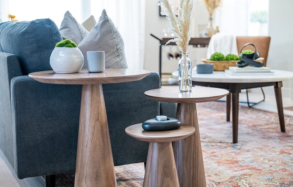 Living room with nested wooden side tables and a blue sofa