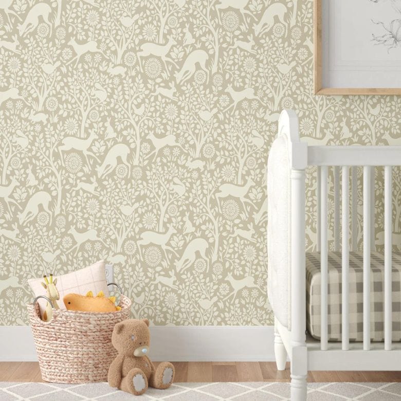 Nursery corner with white crib, patterned wallpaper, basket, and teddy bear