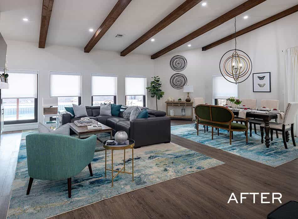 After renovation: Modern farmhouse living room with vaulted ceilings, exposed beams, and a patterned rug