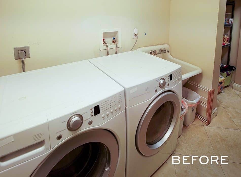A laundry room with a washing machine and a dryer before renovation
