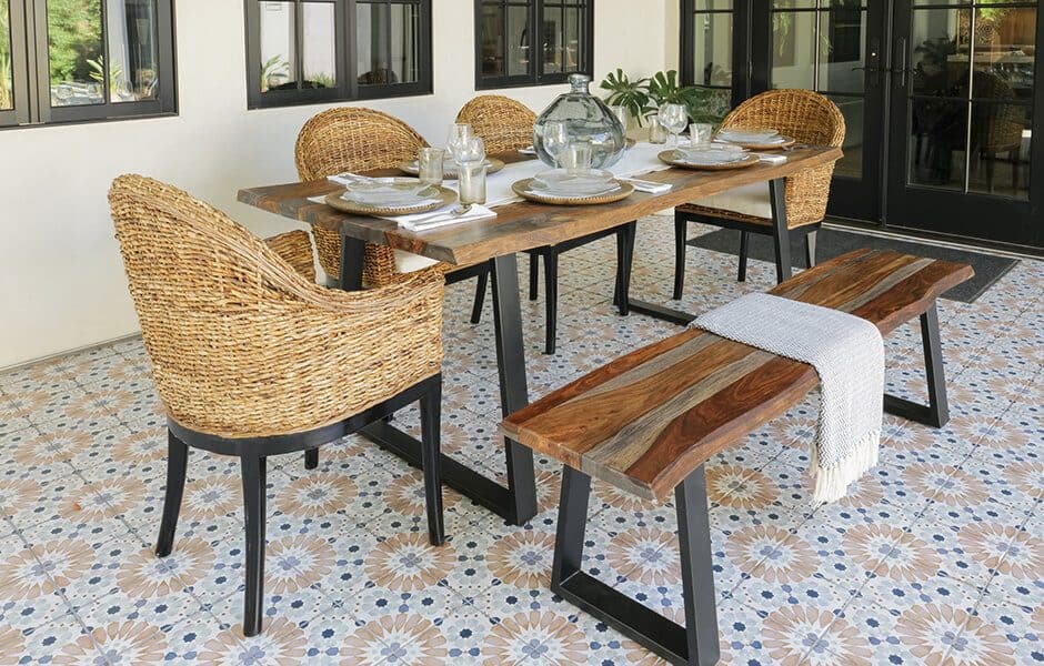 Rustic outdoor dining set with rattan chairs, wood table, and matching bench